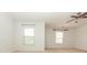 White empty bedroom with two windows and ceiling fan at 5260 Sherwood Way, Cumming, GA 30040