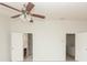 Spacious bedroom with ceiling fan and two open doorways at 5260 Sherwood Way, Cumming, GA 30040