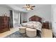 Cozy bedroom featuring decorative furniture, soft carpet and a ceiling fan at 5260 Sherwood Way, Cumming, GA 30040