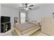 Cozy bedroom features a ceiling fan, natural light and neutral decor at 5260 Sherwood Way, Cumming, GA 30040