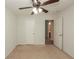 Cozy carpeted bedroom with ceiling fan and an open doorway at 5260 Sherwood Way, Cumming, GA 30040