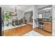 Open-concept dining area with hardwood floors, modern lighting, and views to the kitchen at 5260 Sherwood Way, Cumming, GA 30040