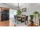 Elegant dining area with hardwood floors, stylish light fixture, and a view to the kitchen at 5260 Sherwood Way, Cumming, GA 30040