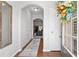 Inviting foyer with hardwood floors, a decorative mirror, and a glimpse into the open-concept living space at 5260 Sherwood Way, Cumming, GA 30040