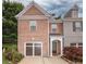 Beautiful brick front home featuring an attached garage and landscaped front yard at 5260 Sherwood Way, Cumming, GA 30040