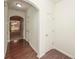 Hallway with hardwood floors leads to a living area visible through an arched doorway at 5260 Sherwood Way, Cumming, GA 30040