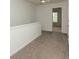 Carpeted upstairs hallway showing the entry to a bedroom with neutral walls at 5260 Sherwood Way, Cumming, GA 30040