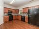 Functional kitchen shows stainless appliances, granite counters, and wood floors under recessed lights at 5260 Sherwood Way, Cumming, GA 30040