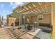 Outdoor patio area with string lights, comfortable seating, and a shaded pergola at 5260 Sherwood Way, Cumming, GA 30040