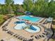 Overhead shot of a community pool with both a main pool and splash pool, lounge seating, and water slide at 5260 Sherwood Way, Cumming, GA 30040