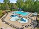 Aerial view of a community pool featuring lap lanes, a waterslide, splashpad, and ample lounge seating at 5260 Sherwood Way, Cumming, GA 30040