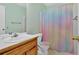 Well lit bathroom featuring a wooden vanity, toilet, and patterned shower curtain at 111 Amberwood Ln, Euharlee, GA 30145