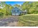 Beautiful blue two-story home featuring a two-car garage and charming front porch at 111 Amberwood Ln, Euharlee, GA 30145