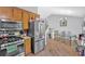 Eat-in kitchen area featuring stainless steel refrigerator, wood cabinets, and dining set for six at 111 Amberwood Ln, Euharlee, GA 30145