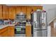 Well lit kitchen featuring wood cabinets, stainless steel appliances, and tile backsplash at 111 Amberwood Ln, Euharlee, GA 30145