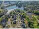 Stunning aerial view of homes nestled among trees, showcasing the neighborhood's serene and natural setting near a lake at 2331 Kinsale Nw Pt, Kennesaw, GA 30152