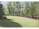 Expansive backyard with manicured lawn and mature trees, offering plenty of space for outdoor activities at 2331 Kinsale Nw Pt, Kennesaw, GA 30152