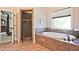 This bathroom is well-appointed with a glass shower, soaker tub, and access to the main bedroom and walk-in closet at 2331 Kinsale Nw Pt, Kennesaw, GA 30152