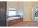 Relax in this soaker tub next to the window after stepping out of the glass enclosed shower at 2331 Kinsale Nw Pt, Kennesaw, GA 30152