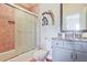 This bathroom features a tub, a shower with a sliding glass door, and storage space underneath the sink at 2331 Kinsale Nw Pt, Kennesaw, GA 30152