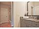 Well-lit bathroom featuring a granite vanity, under-mount sink, tile floors, and a glass shower enclosure at 2331 Kinsale Nw Pt, Kennesaw, GA 30152