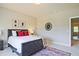 Bedroom featuring a leather bed, white bedding, and colorful modern artwork at 2331 Kinsale Nw Pt, Kennesaw, GA 30152