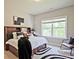 Well-lit bedroom with a bed, a large window and a modern rug at 2331 Kinsale Nw Pt, Kennesaw, GA 30152