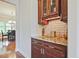 Elegant butler's pantry with granite countertops, custom cabinets, and glass shelving at 2331 Kinsale Nw Pt, Kennesaw, GA 30152