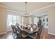 Formal dining room with an elegant chandelier and a view to an office behind a sliding barn door at 2331 Kinsale Nw Pt, Kennesaw, GA 30152