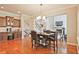 Cozy dining room features hardwood floors, modern chandelier, with access to a kitchen and staircase at 2331 Kinsale Nw Pt, Kennesaw, GA 30152