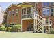 Back exterior view of a brick home featuring a screened porch and stairs to the yard at 2331 Kinsale Nw Pt, Kennesaw, GA 30152