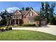 Two-story brick home with manicured lawn, and a two car garage at 2331 Kinsale Nw Pt, Kennesaw, GA 30152