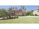 Beautiful brick home featuring a lush green lawn, mature trees, and an inviting driveway at 2331 Kinsale Nw Pt, Kennesaw, GA 30152