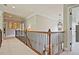 This upstairs hallway leads to several bedrooms and features decorative lighting and a detailed railing at 2331 Kinsale Nw Pt, Kennesaw, GA 30152