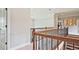 Hallway with hardwood floors and wooden railing at 2331 Kinsale Nw Pt, Kennesaw, GA 30152