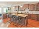 Bright, spacious kitchen with hardwood floors, granite countertops, stainless appliances, and a kitchen island with seating at 2331 Kinsale Nw Pt, Kennesaw, GA 30152