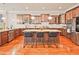 This spacious kitchen features stainless steel appliances, wood floors and cabinets, and a center island with seating at 2331 Kinsale Nw Pt, Kennesaw, GA 30152