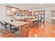Open kitchen with wooden cabinets, white subway tile, stainless steel appliances, and seating at the island at 2331 Kinsale Nw Pt, Kennesaw, GA 30152