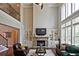 Elegant living room with a stone fireplace, built-in shelving, and soaring ceilings at 2331 Kinsale Nw Pt, Kennesaw, GA 30152