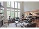 Grand living room with soaring ceilings, fireplace, hardwood floors, and plenty of natural light at 2331 Kinsale Nw Pt, Kennesaw, GA 30152