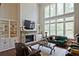 Inviting living room with soaring ceilings, built-in shelving, and large windows offering beautiful views at 2331 Kinsale Nw Pt, Kennesaw, GA 30152