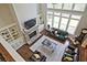 Bright living room with stone fireplace, built-in bookshelves, and large windows overlooking the backyard at 2331 Kinsale Nw Pt, Kennesaw, GA 30152