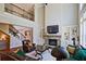Cozy living room featuring a stone fireplace, built-in shelves, and large windows offering plenty of natural light at 2331 Kinsale Nw Pt, Kennesaw, GA 30152