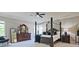 Serene main bedroom with a four-poster bed, complemented by a decorative dresser and ample natural light at 2331 Kinsale Nw Pt, Kennesaw, GA 30152
