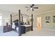 Elegant main bedroom with dark wood furniture, including a four-poster bed, and stylish accents at 2331 Kinsale Nw Pt, Kennesaw, GA 30152