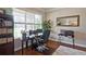 Bright home office with large window, hardwood floors, and built-in shelving for optimal organization and productivity at 2331 Kinsale Nw Pt, Kennesaw, GA 30152