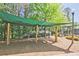 Shaded playground area with swings and climbing structures, providing a fun and safe space for children to play at 2331 Kinsale Nw Pt, Kennesaw, GA 30152