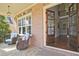 Inviting front porch with stone flooring, brick pillars, and comfortable seating at 2331 Kinsale Nw Pt, Kennesaw, GA 30152