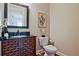 Elegant powder room with dark wood vanity, modern fixtures, and stylish decor at 2331 Kinsale Nw Pt, Kennesaw, GA 30152
