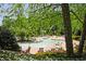 Community splash pad with water features, surrounded by tables, chairs, and lush landscaping at 2331 Kinsale Nw Pt, Kennesaw, GA 30152